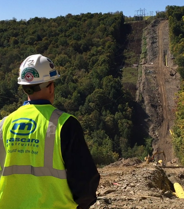 Mascaro Construction worker looking over a job site