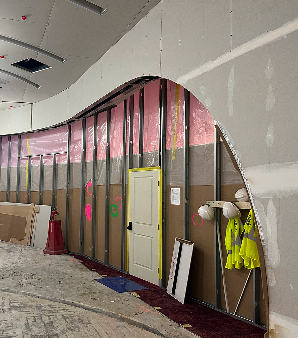 Mascaro Construction commercial interior build-out with custom curved wall framing and drywall work.