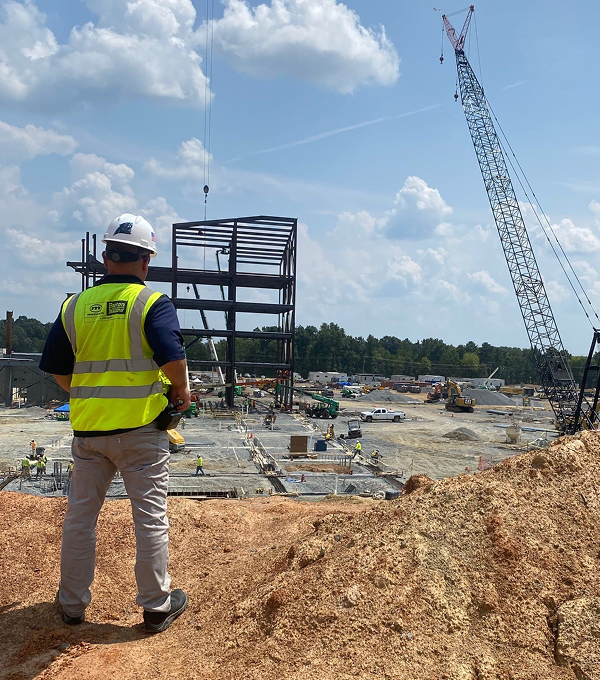 Mascaro Construction preconstruction site planning featuring project oversight, site evaluation, structural steel installation, and construction logistics coordination on an active development site.