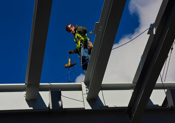 Mascaro construction work walking on steel beams on job site