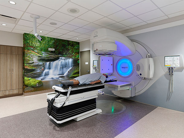 Advanced cancer treatment equipment installed in a modern healthcare facility treatment room.