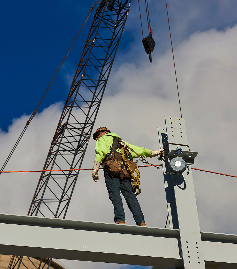 Mascaro worker harnessed and walking on a steel beam